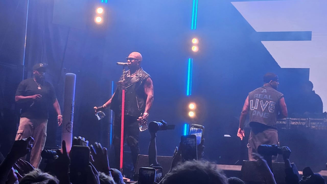 Man on stage with two bottles