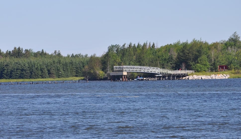 the beginning of a bridge over a lake