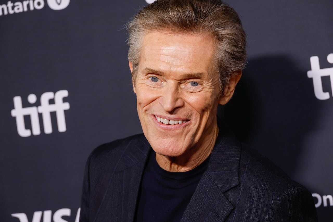 Man smiles at camera.
