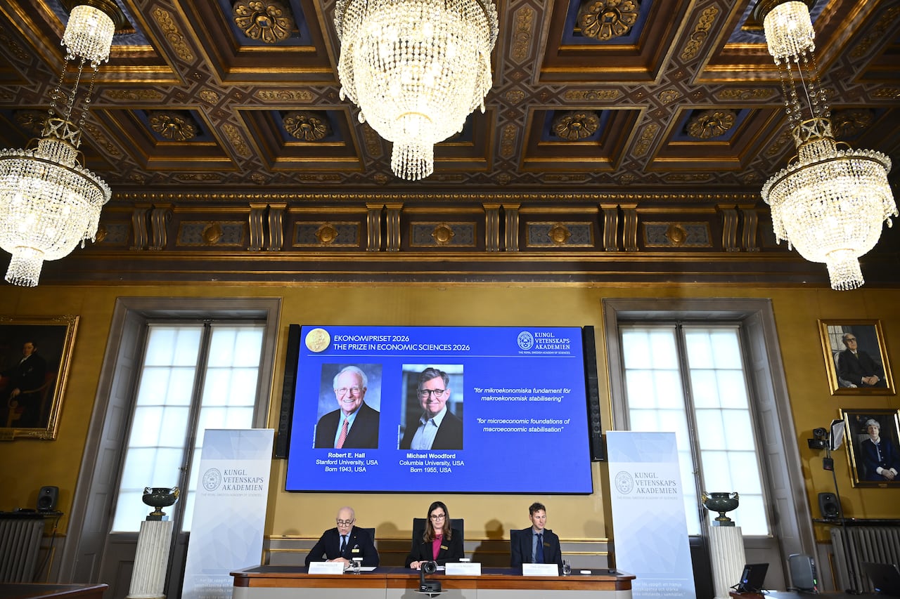 Two men's photos on a screen.