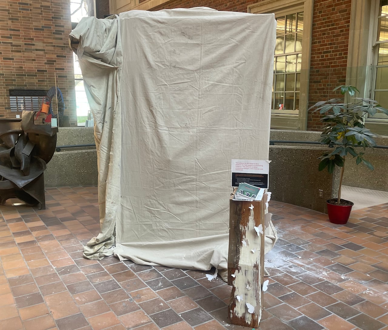 A blanket is covering an art installation.