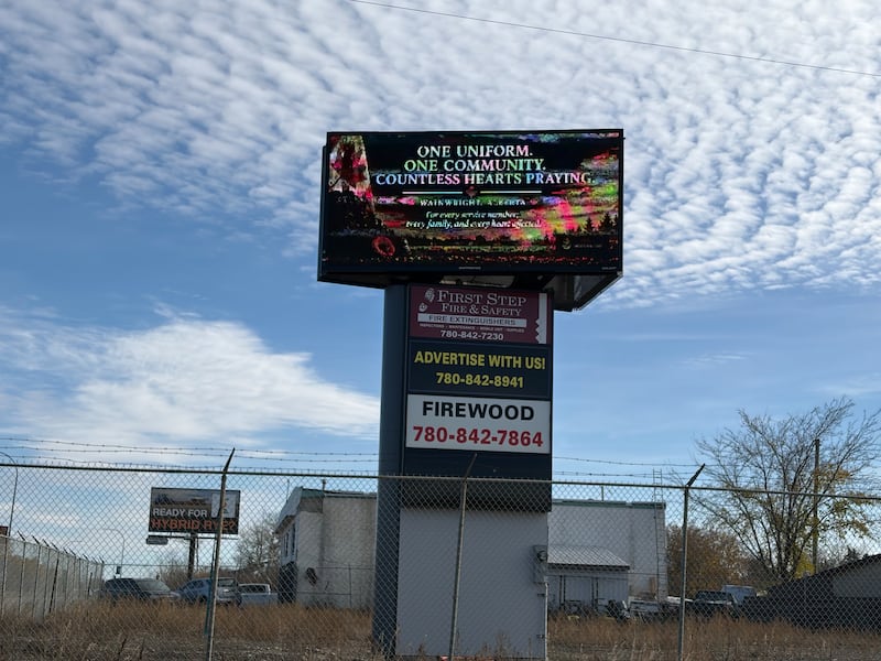 An electronic message board at the west entrance to Wainwright, Alta., reads, "One uniform, one community, countless hearts praying," on Oct. 19, 2026, two days after the deady incident at CFB Wainwright. (Nicole Weisberg / CTV News Edmonton)