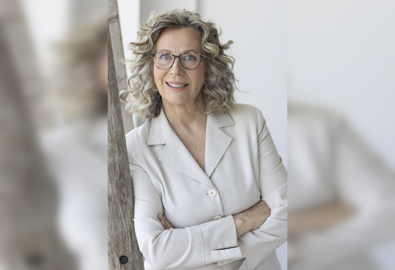 A woman wearing white suit