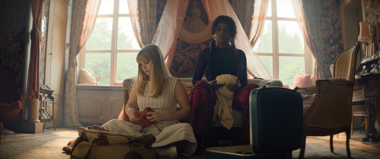 Two women sit in a living room.