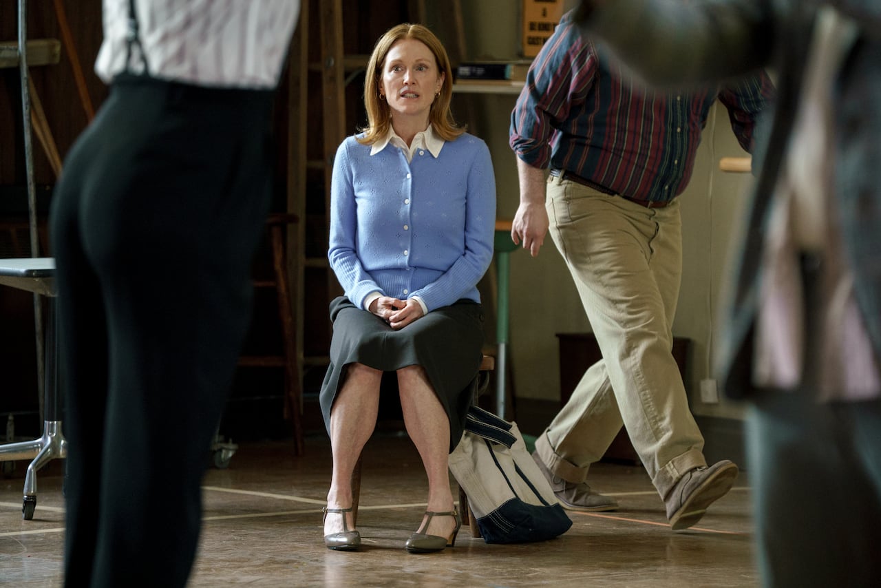 A woman sits on a chair