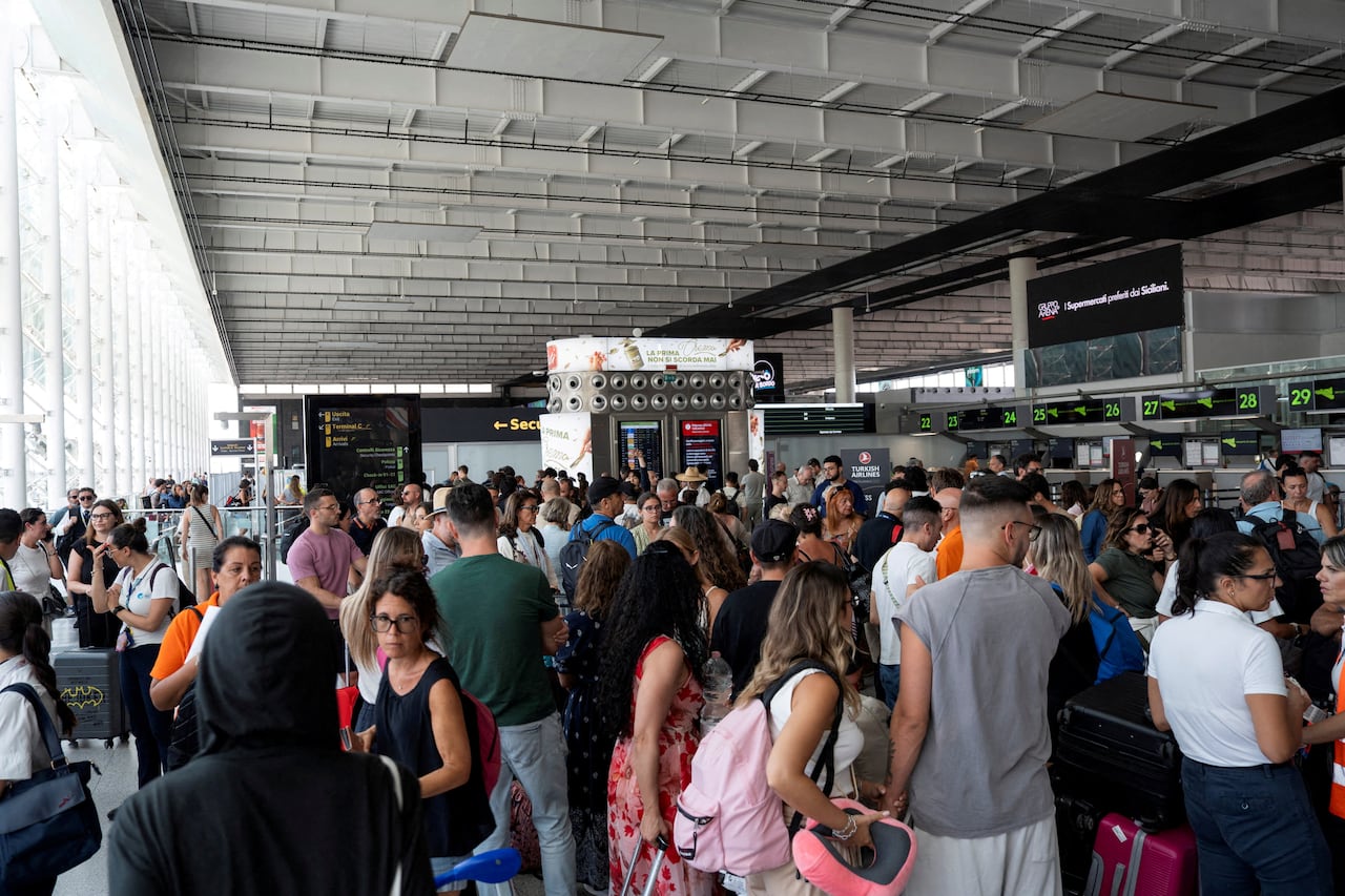 Travellers packed inside an airport.