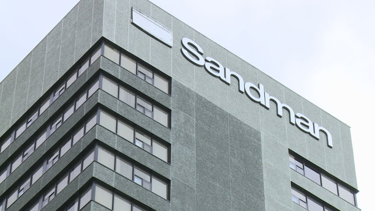 The top of a hotel reads 'Sandman'.