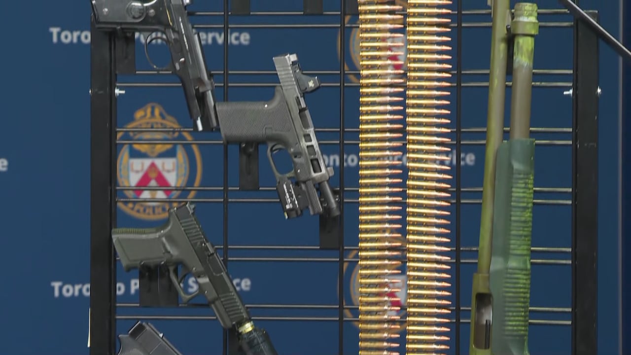 A gun and bullets displayed at a Toronto police press conference.