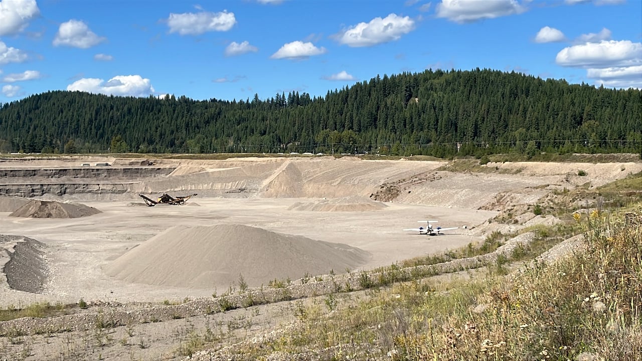 A plane at the bottom of a gravel pit.