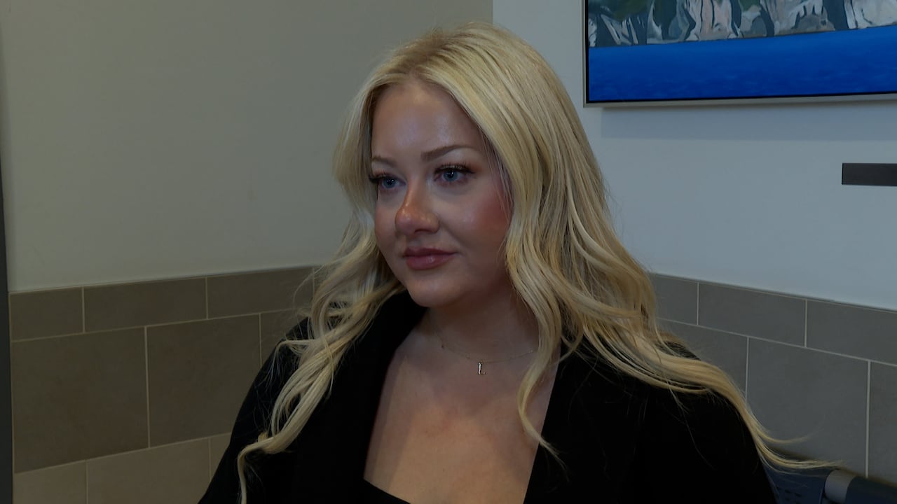 Woman with blond hair, looking serious.