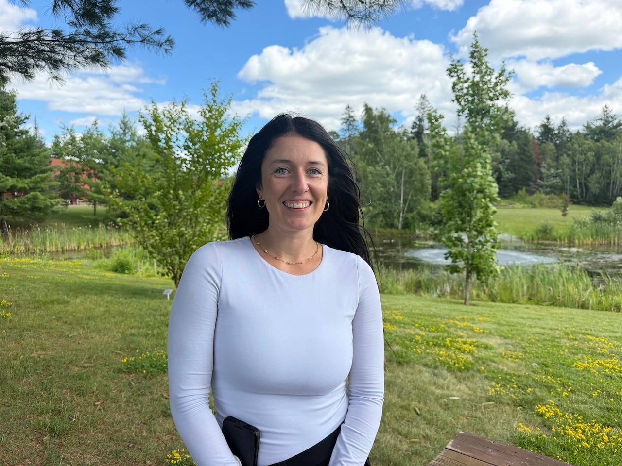 Woman smiling at camera in a park