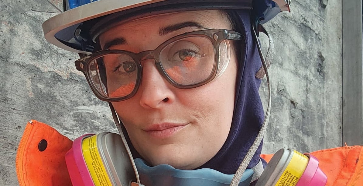 a close up of a person in glasses and a hard hat