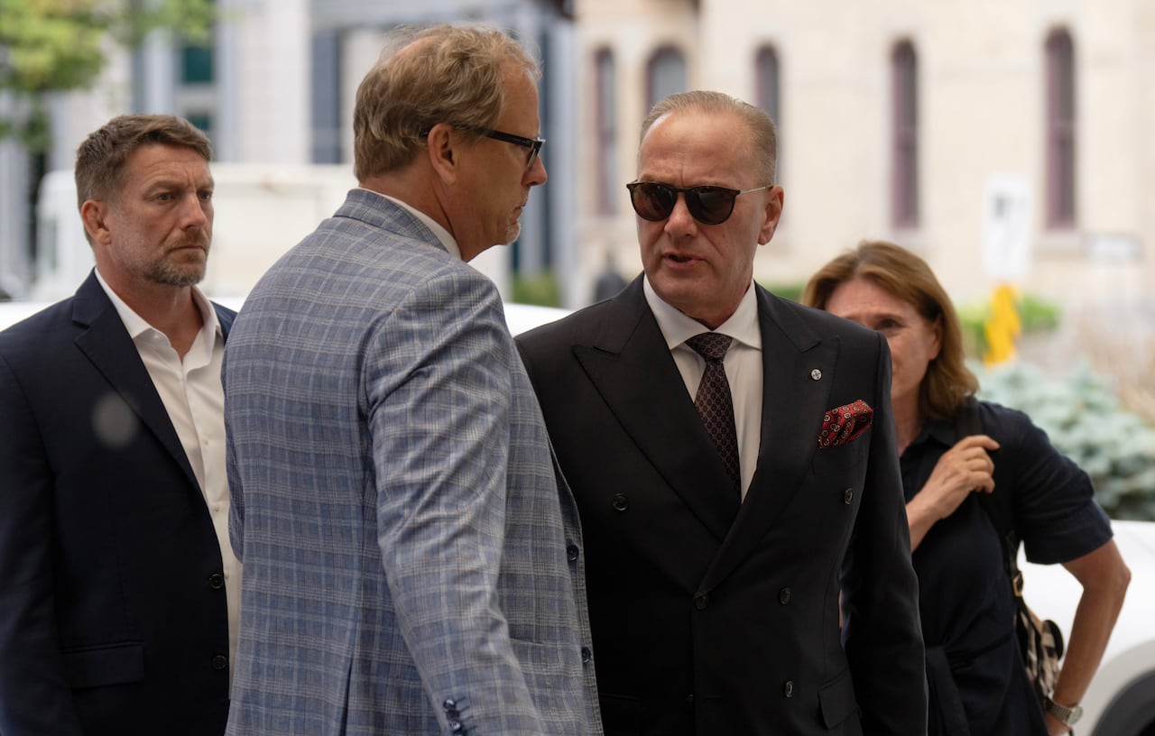 David Henschel, a foreign defence contractor who pleaded guilty to punching a protestor outside the CANSEC defence expo, speaks with his lawyer as he arrives at the courthouse in Ottawa, Wednesday, July 22, 2026.