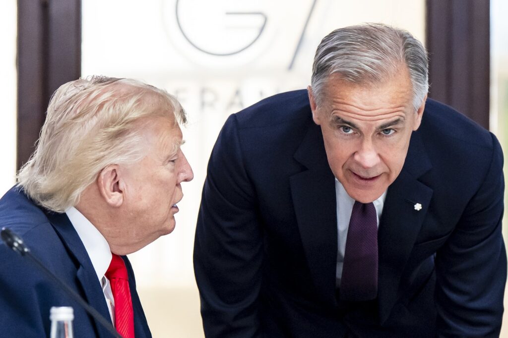 U.S. President Donald Trump and Canada’s Prime Minister Mark Carney speak at the G7 working luncheon, during the G7 summit in Evian-les-Bains, France, on Tuesday, June 16, 2026. THE CANADIAN PRESS/Christopher Katsarov