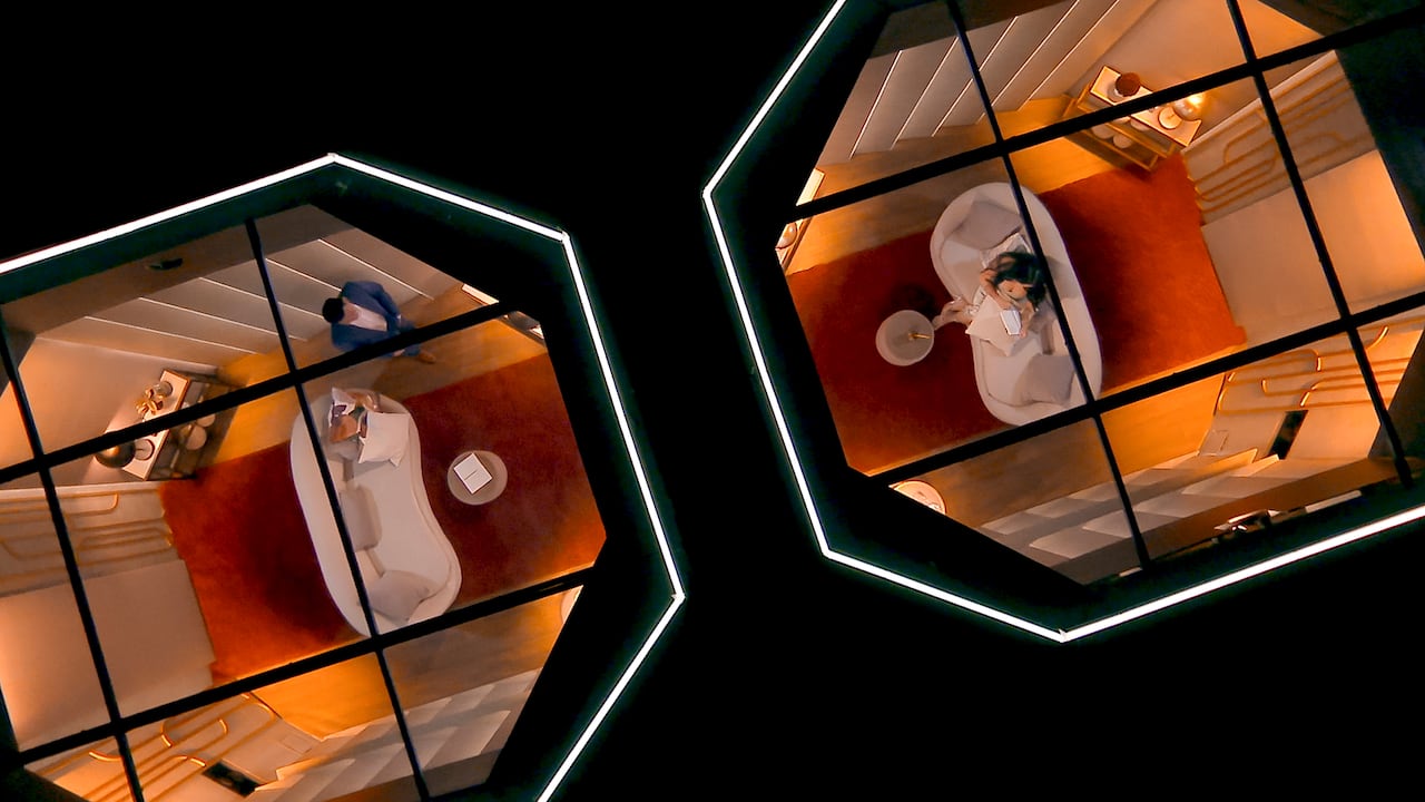 an overhead image of a man and women talking to eachother in pods with a wall in between for a reality dating show