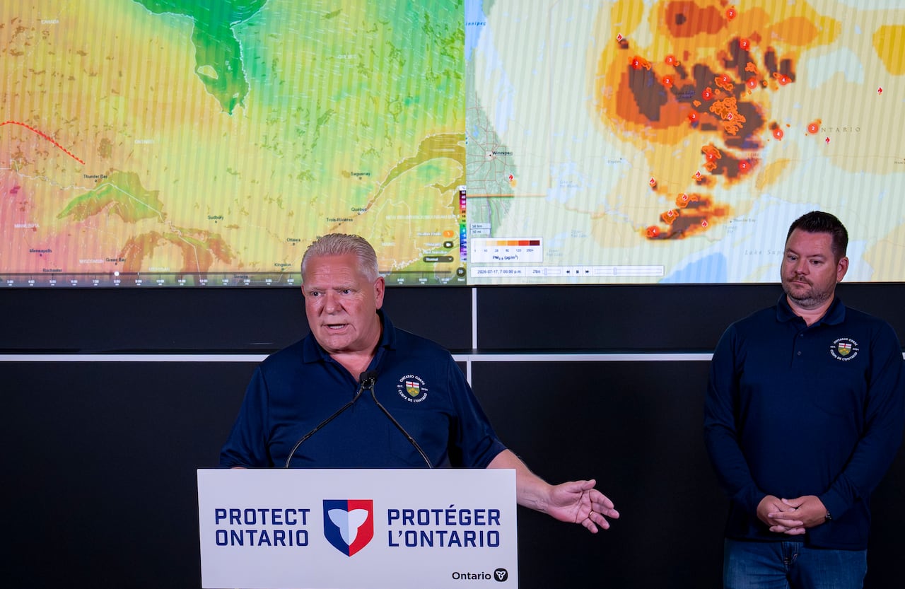 Two people are seen standing in front of a heat map.