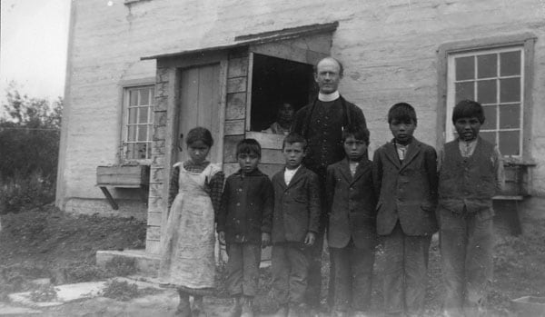 Students pose for a photo outside of the Indian Day School in 1931 in Fort Norman, now Tulita, N.W.T.