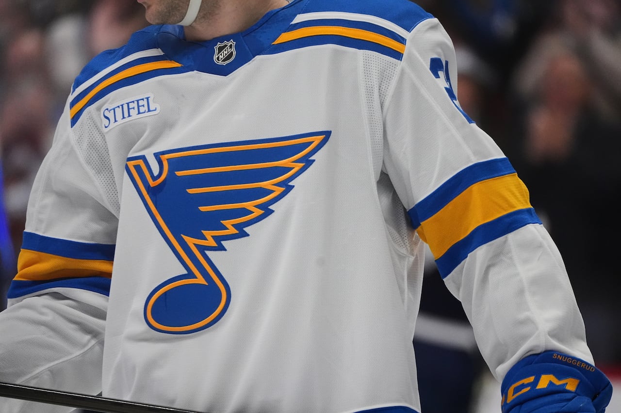 A neck-down shot of a player in a St. Louis Blues jersey.