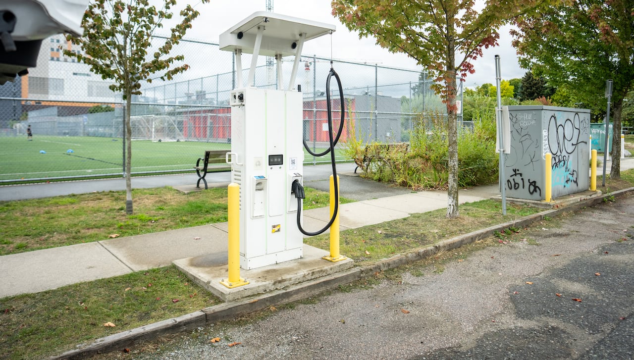 An EV charging station is seen at a park on a cloudy day.