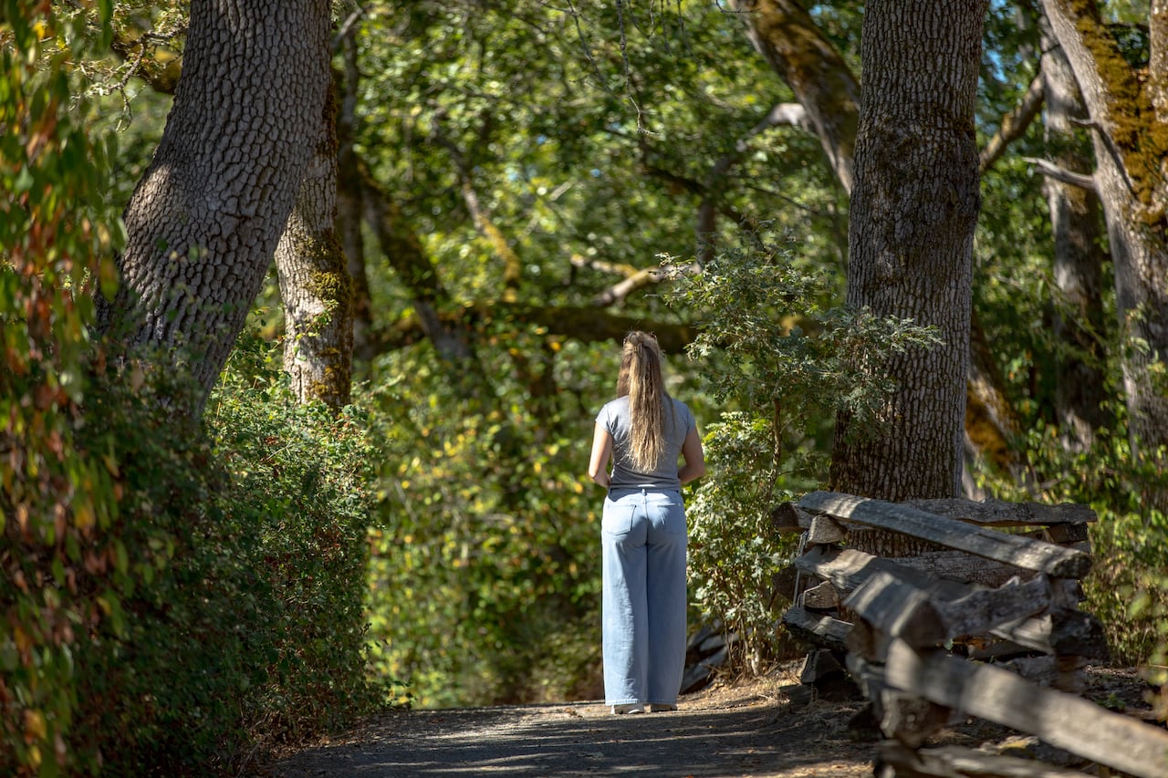 a woman walks in a park