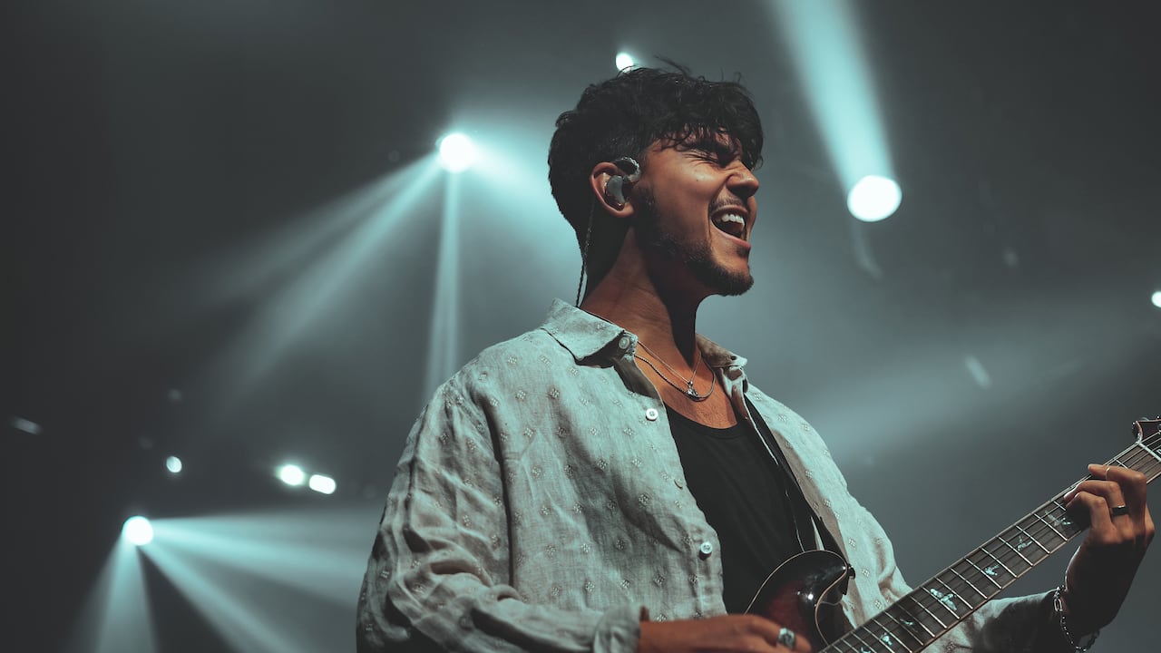 Man performs with guitar.
