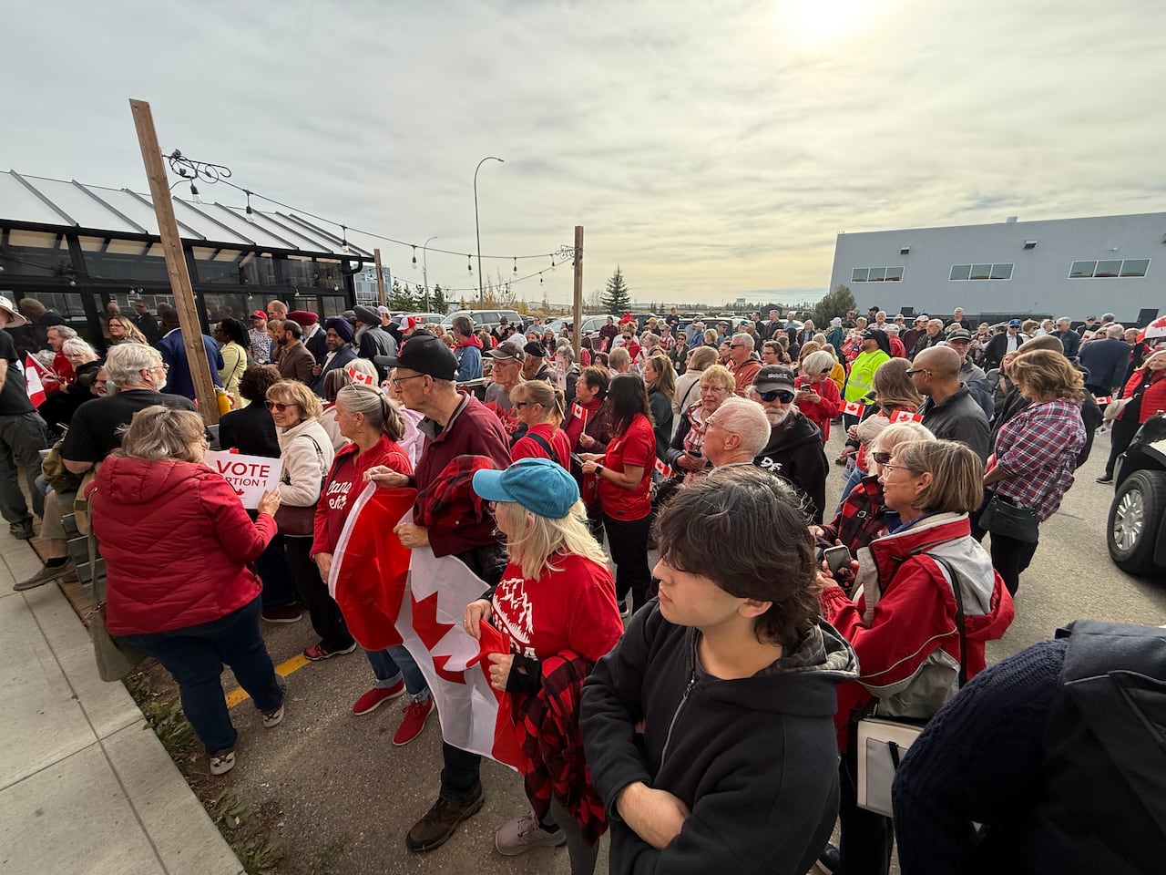 A large gathering of people. Canadian flags are visible in this image.