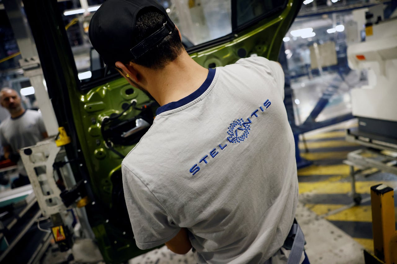 The logo of Stellantis is seen on the t-shirt of an employee who works on the automotive assembly line for Peugeot 308 and Peugeot 408 cars at the Stellantis factory in Mulhouse, eastern France, June 2, 2026.