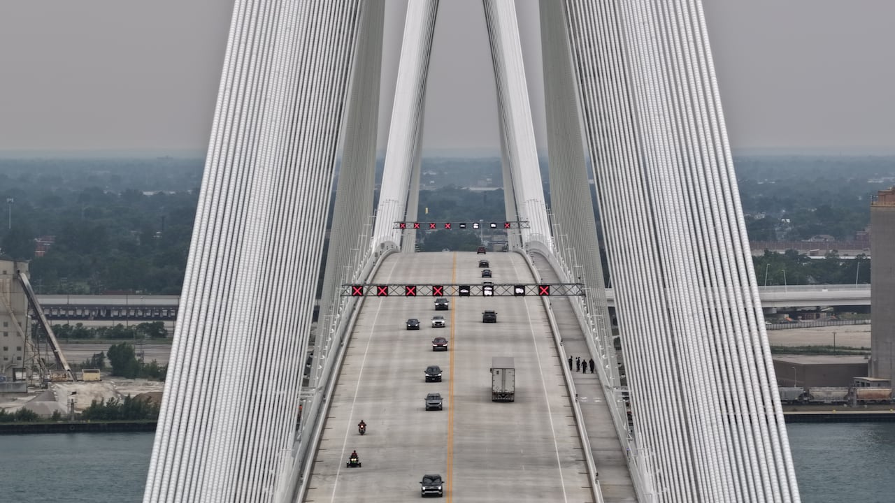 Cars and trucks move across the new Gordie Howe International Bridge linking Detroit, Mich., and Windsor, Ont., on the day it opened to traffic on July 27, 2026.