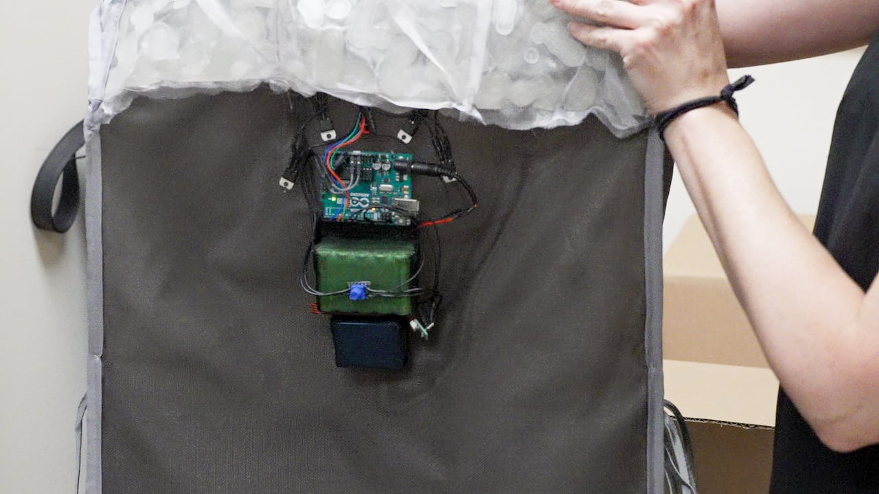 Electronics hanging on a grey rectangle