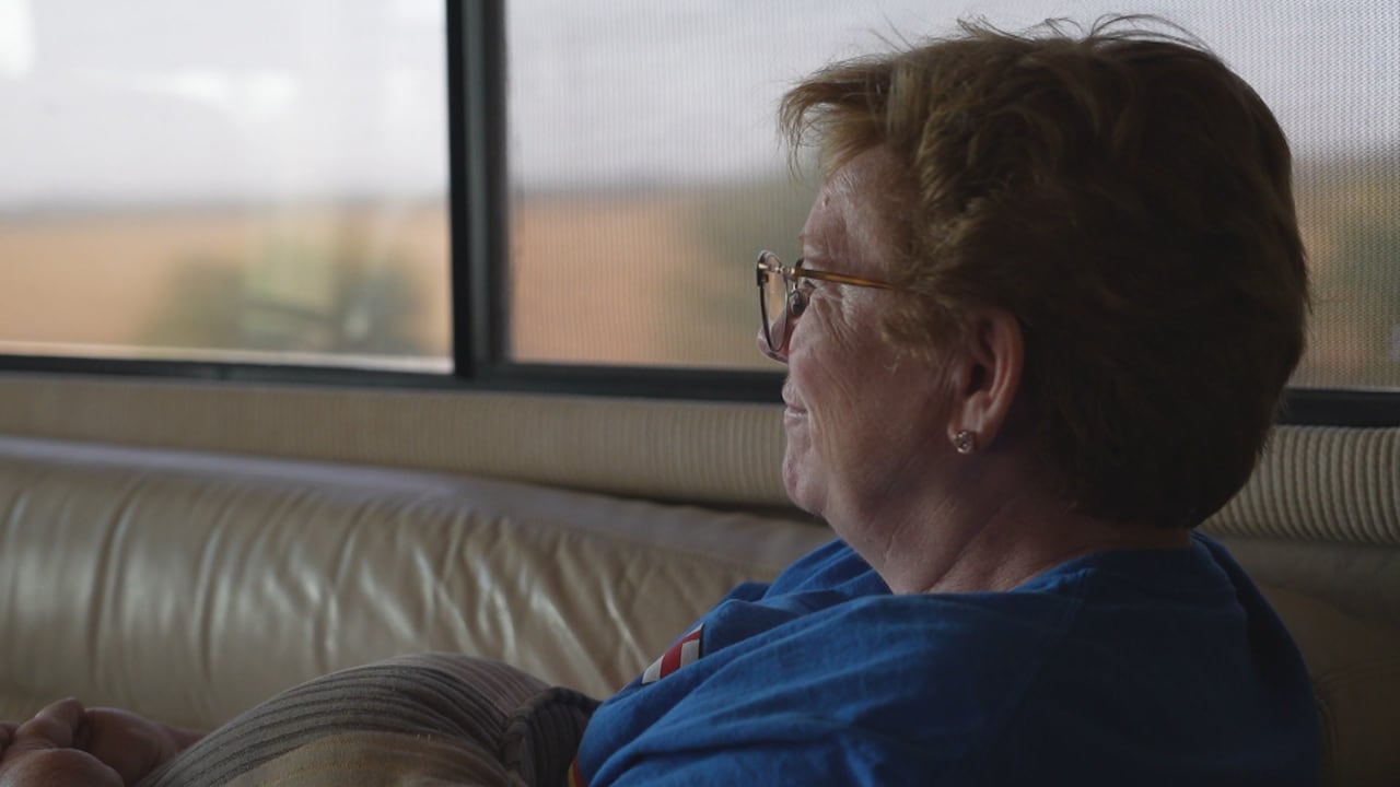 A woman sits on a bus.