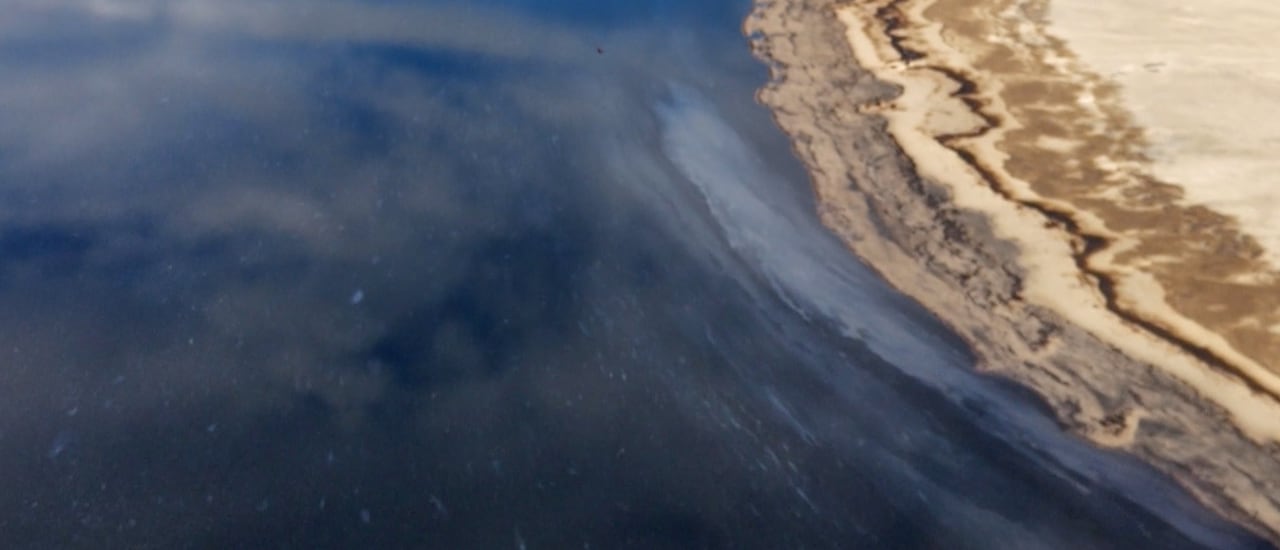 Water is shown with what appears slicks of hydrocarbons.