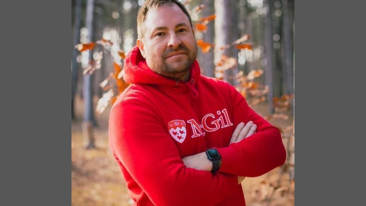 A man in a university sweater.