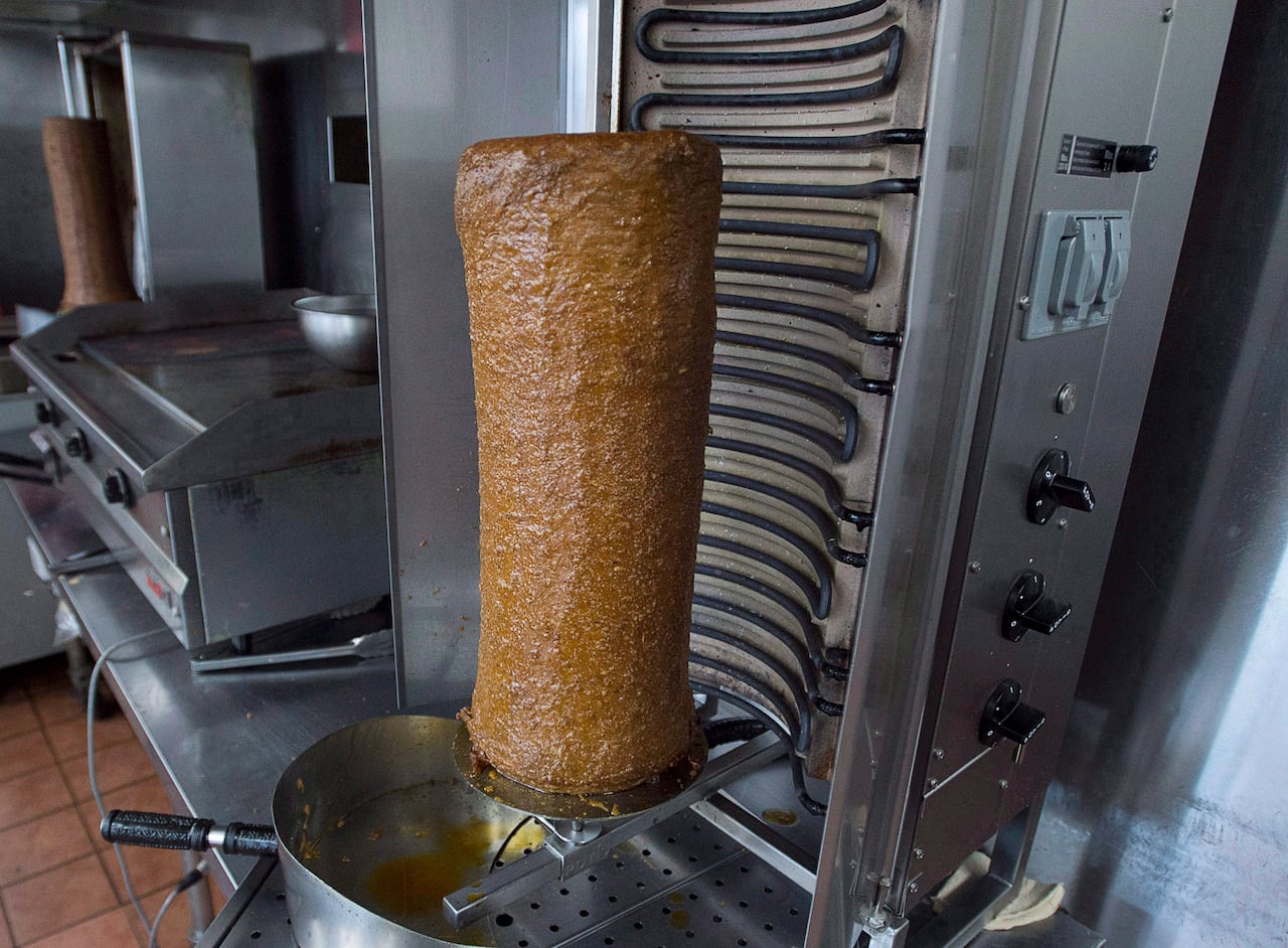 A rotating spit of donair meat is shown at a Halifax donair shop.