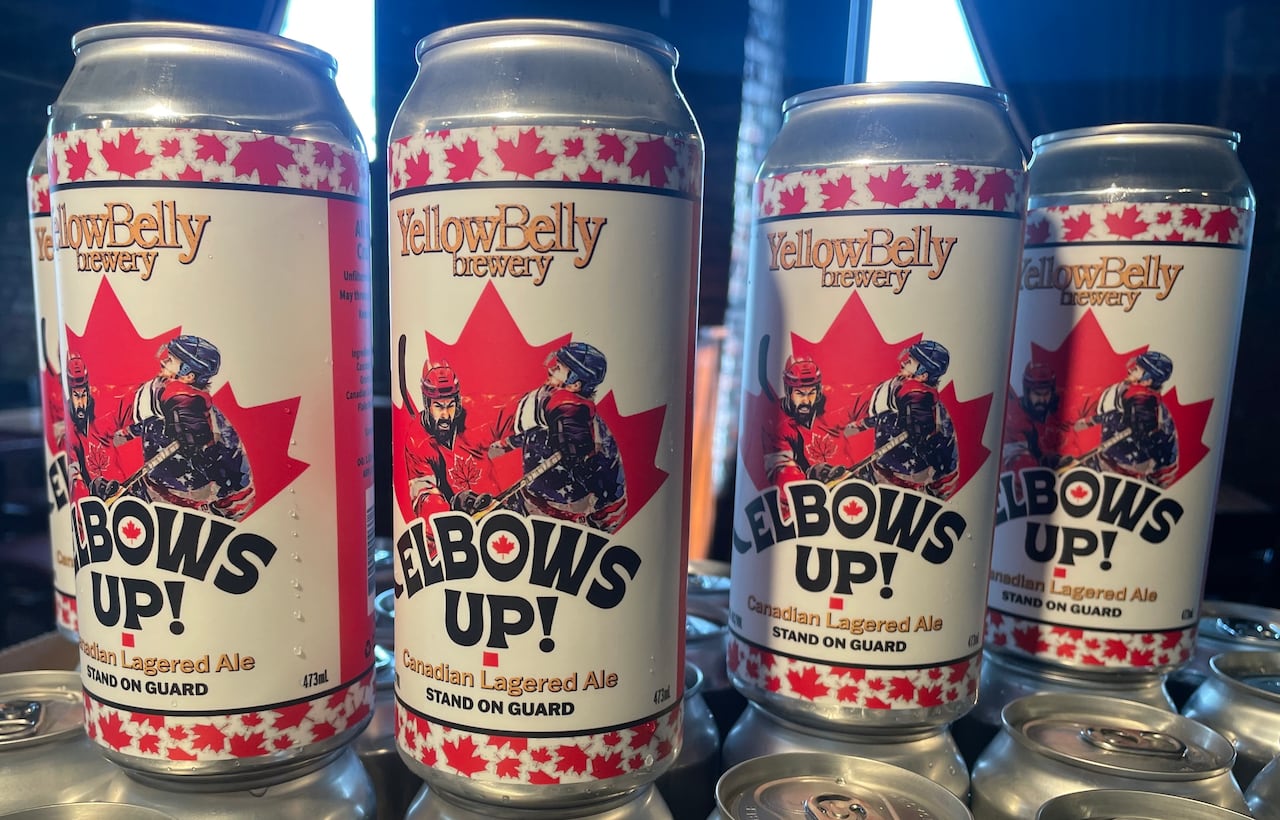 Four cans with an image of a man in a red jersey punching someone in a blue jersey.