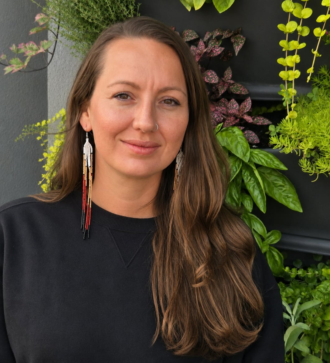 Woman stands in front of a living wall.