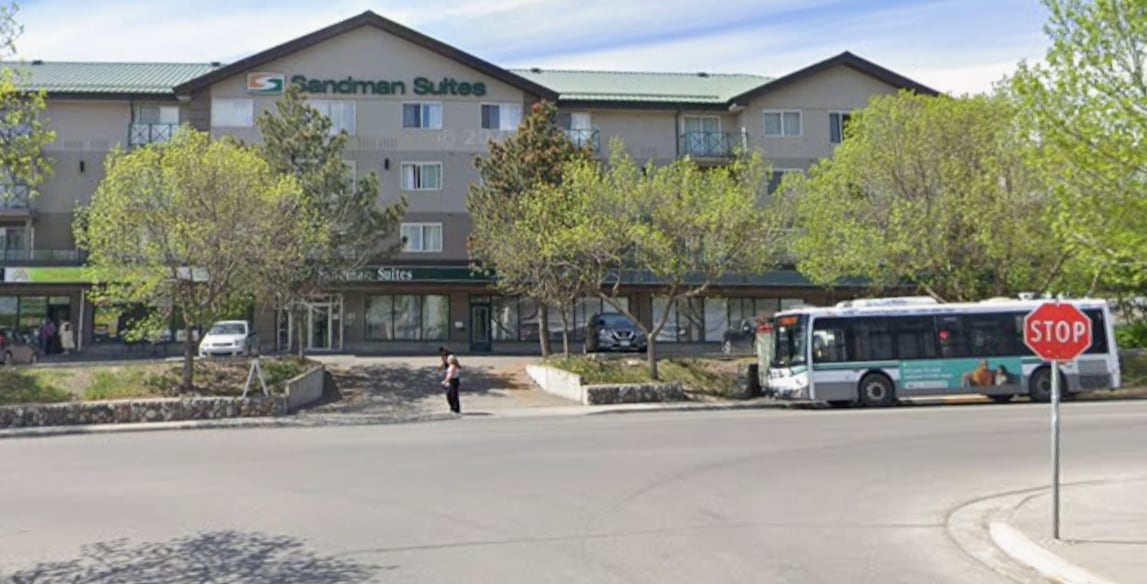 A hotel with the words 'Sandman Suites' on it.