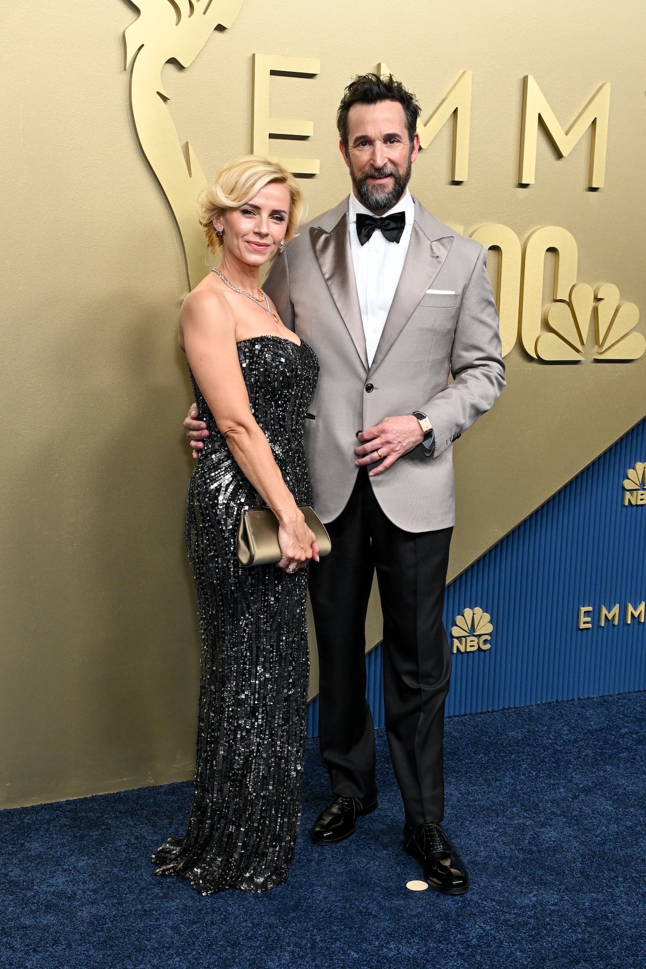 A picture of a man and women posing together on the Emmys red carpet