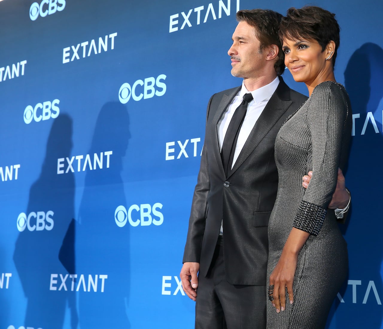 man in suit poses with woman in grey dress