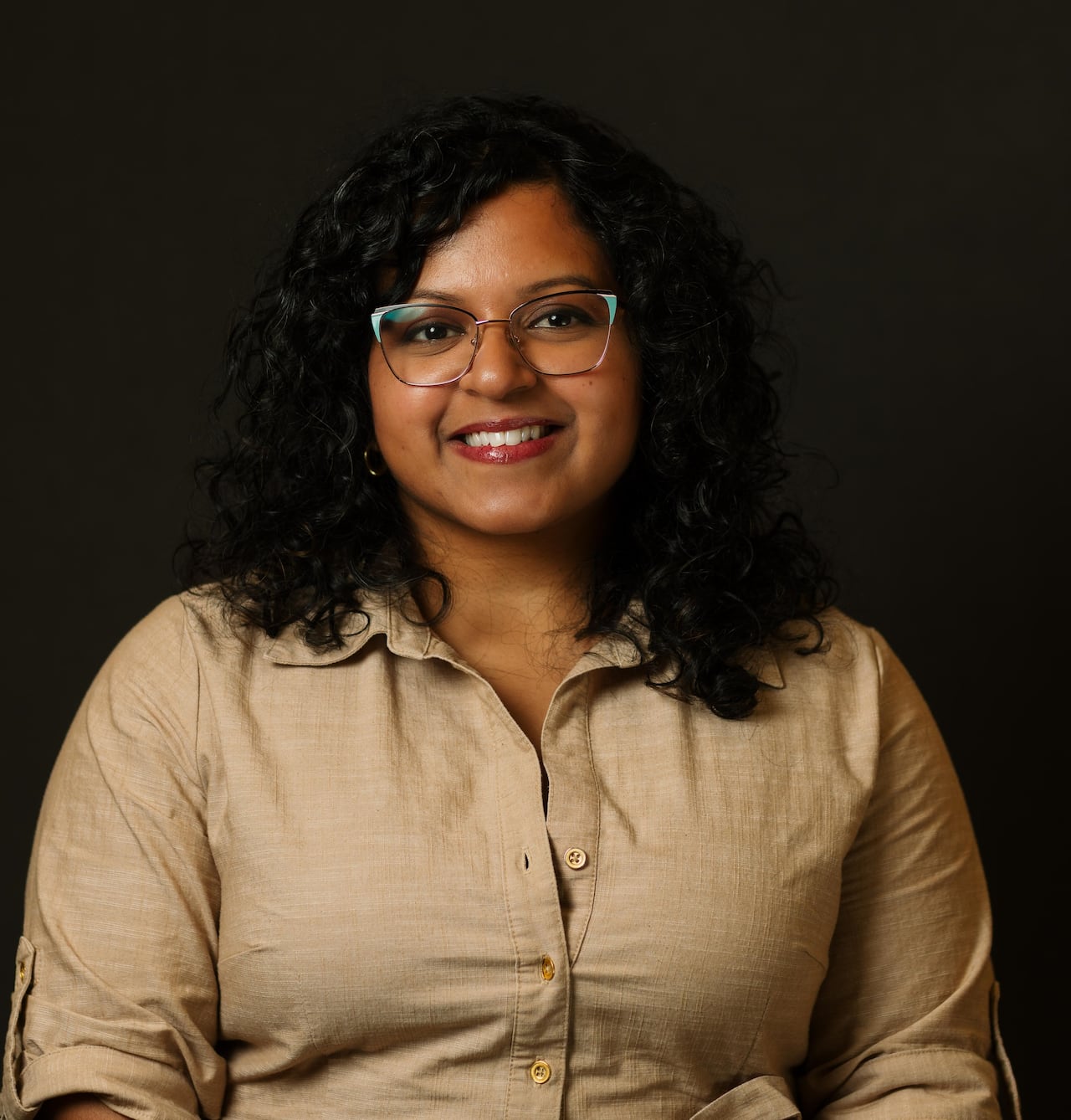 A portrait of a woman on a black background.
