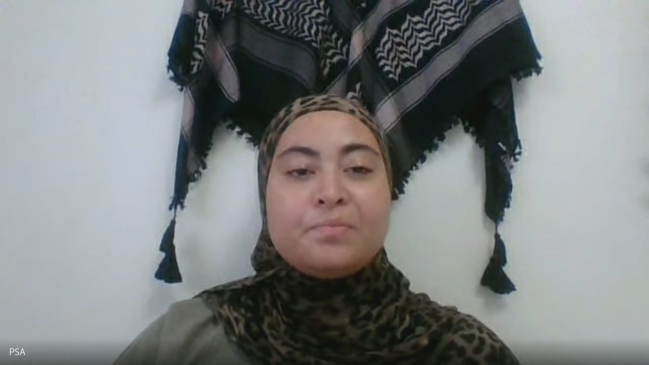 A woman in a cheetah-print hijab.