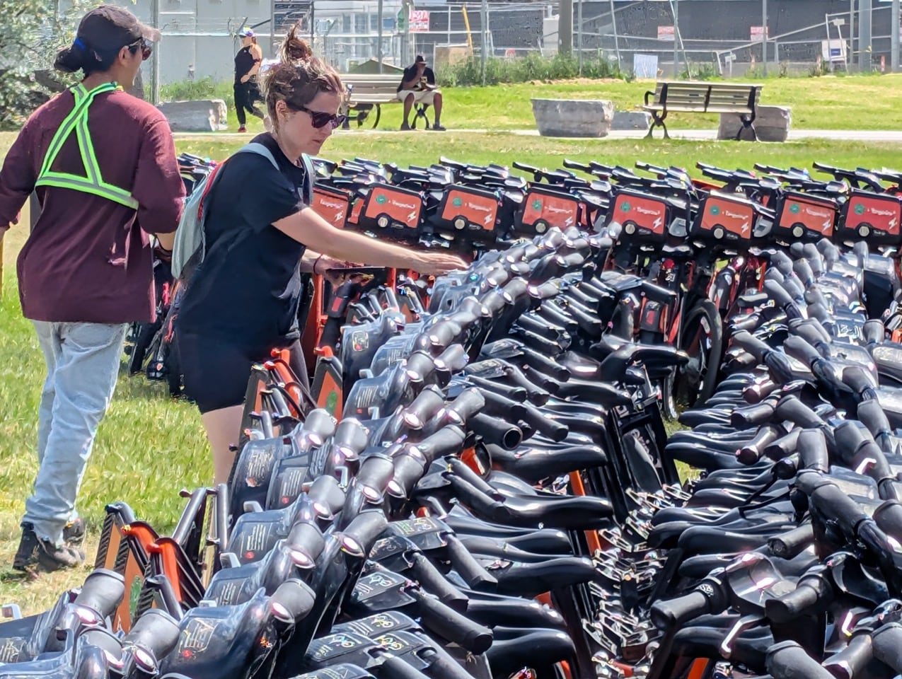 Two women with lots of parked Bike Share Toronto bikes