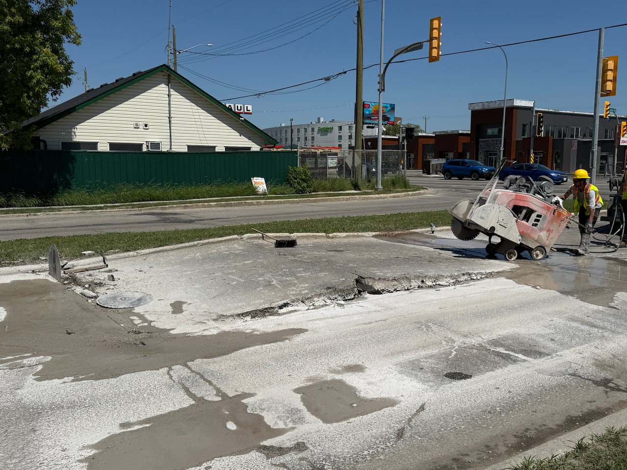 City crews use equipment to fix a road.