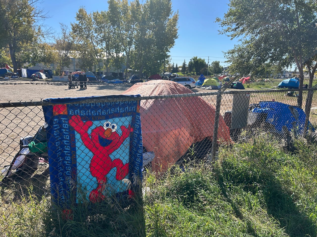 tents are seen on a lot with grass and gravel