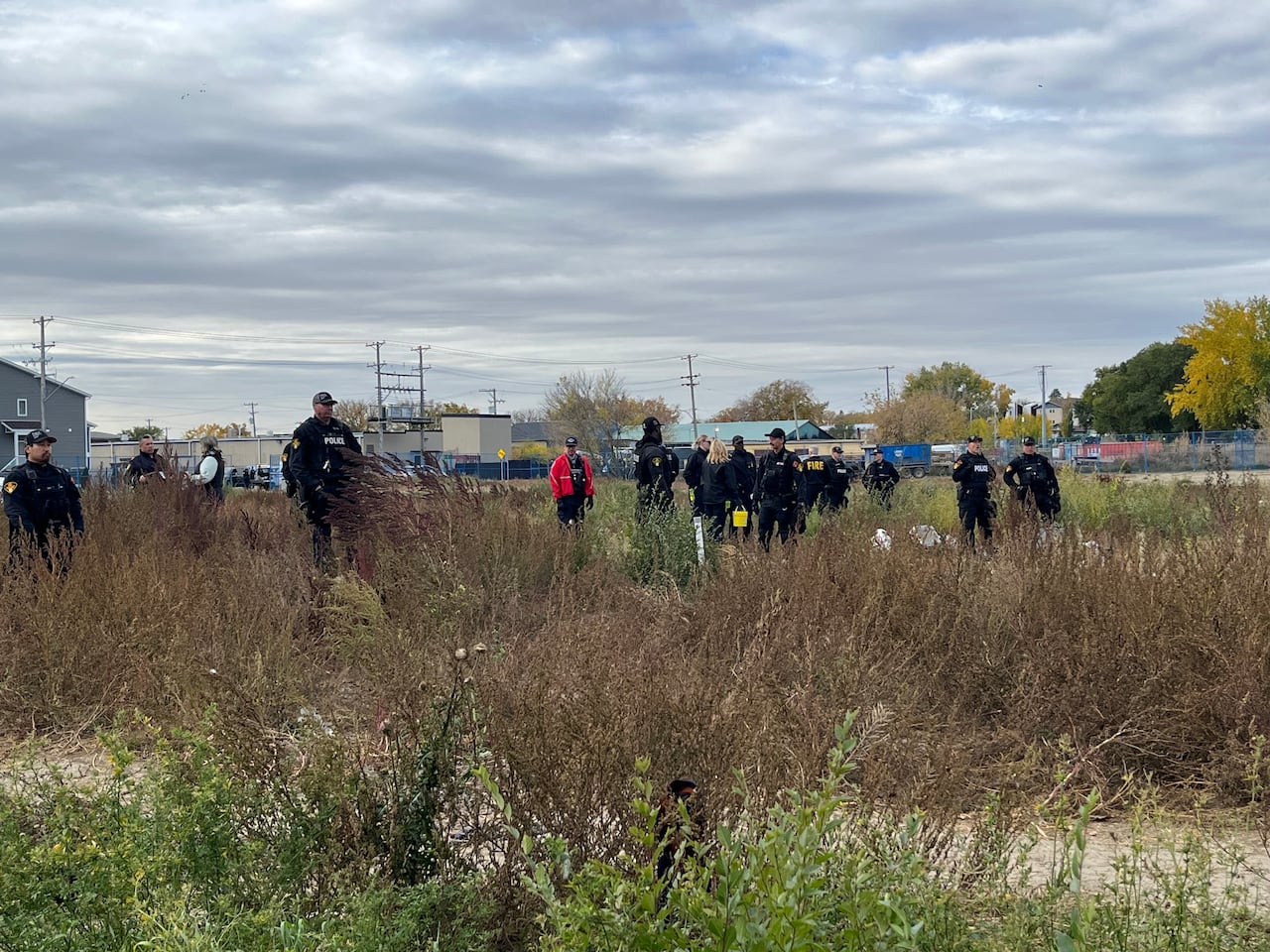 about 10 police officers stand in a field