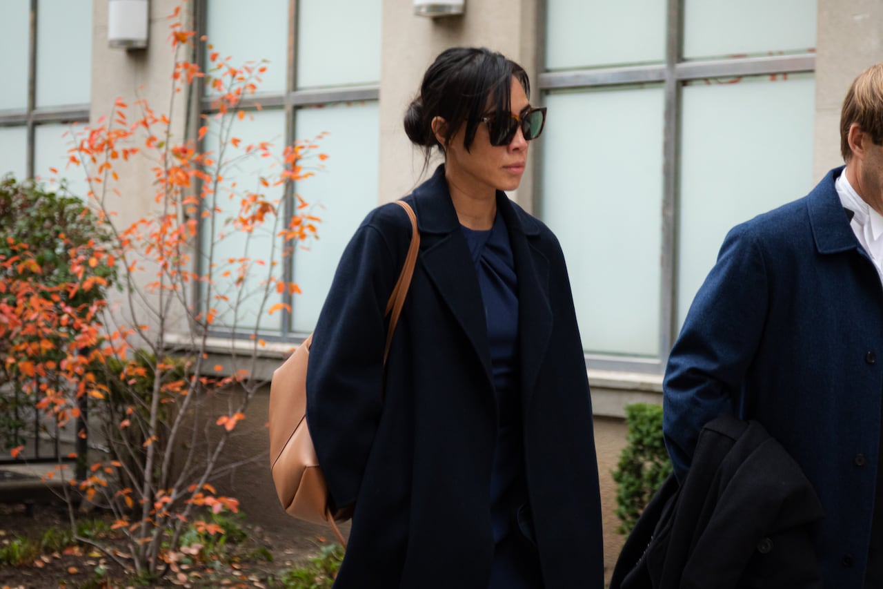 Photo shows suspended lawyer Singa Bui and her lawyer, Andrew Wray, leaving Superior Court in Toronto on Friday, October 25, 2024.