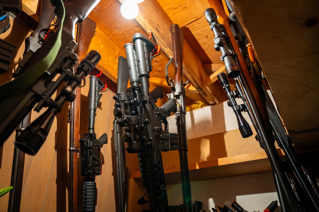 Several long guns are seen hanging.