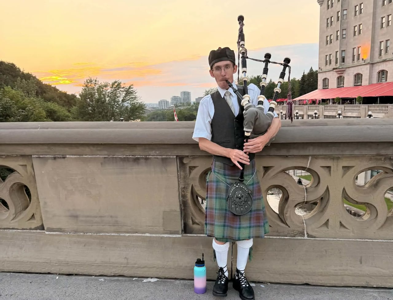 A bagpiper at sunset.