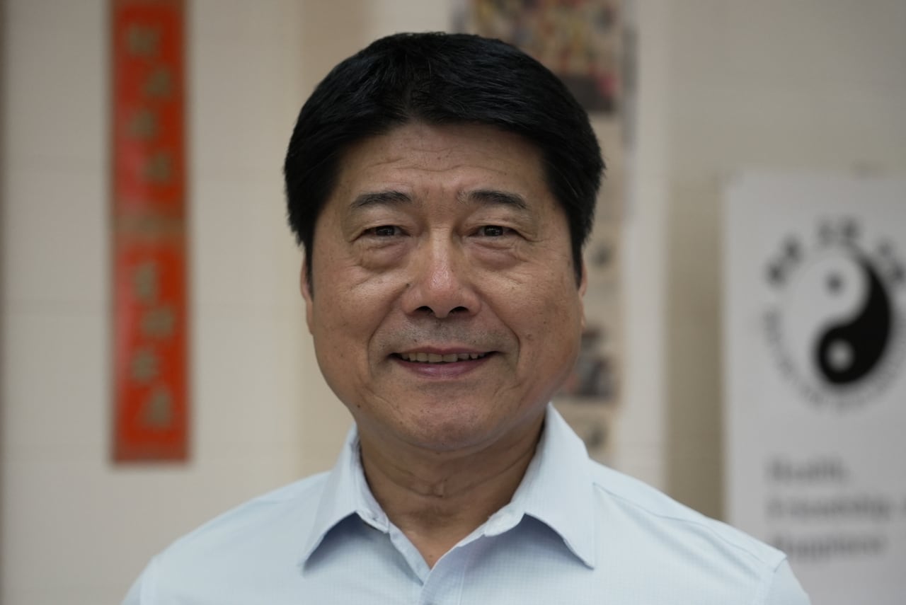 A person is seen standing in a Tai Chi studio.