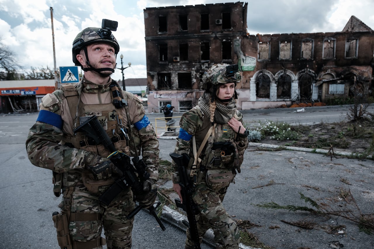 A Ukrainian soldier looks up to the sky after hearing the sound of a drone during a patrol in the frontline city of Kupiansk, Kharkiv region, on September 24, 2022, amid the Russian invasion of Ukraine. In the northeastern town of Kupiansk, which was