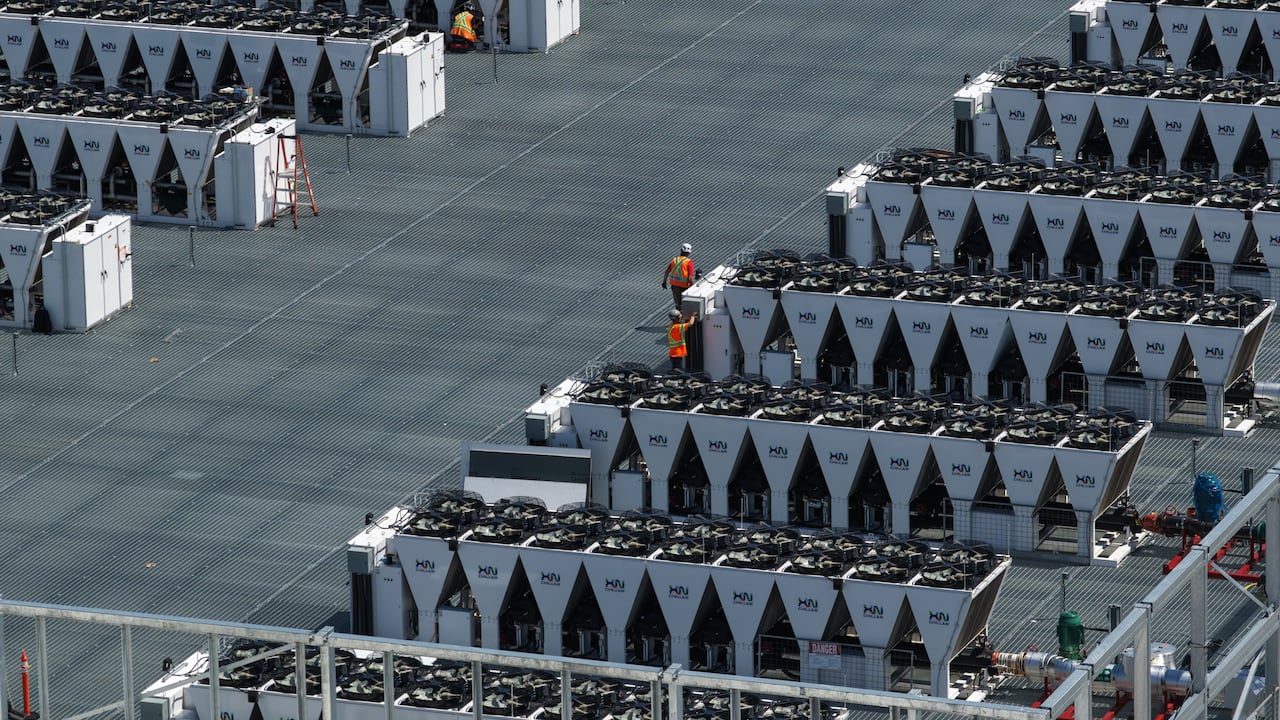 A top down view of two construction workers on a site where a data centre is being built.